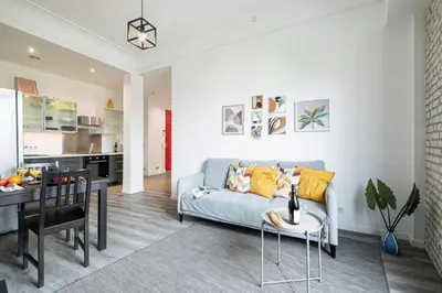 a living room with a couch and a table at MY CASA - OLIVETTO - Superb city center apartment with AC in Nice