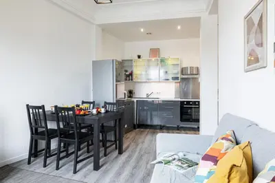 a kitchen and dining room with a table and chairs at MY CASA - OLIVETTO - Superb city center apartment with AC in Nice