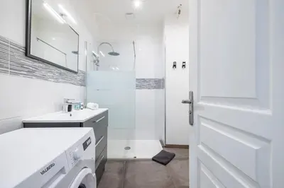 a white bathroom with a sink and a washing machine at MY CASA - OLIVETTO - Superb city center apartment with AC in Nice