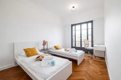 a white room with two beds and a window at MY CASA - OLIVETTO - Superb city center apartment with AC in Nice