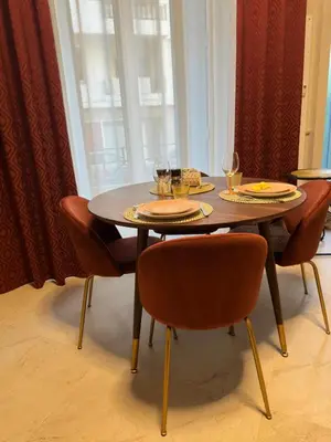 a wooden table with chairs and plates and wine glasses at Extraordinaire grand studio au centre 6 minutes à pied de la plage et l'hôtel Negresco in Nice