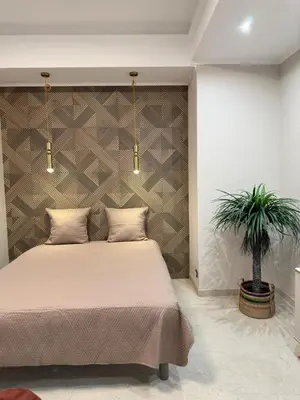 a bedroom with a bed and a potted plant at Extraordinaire grand studio au centre 6 minutes à pied de la plage et l'hôtel Negresco in Nice