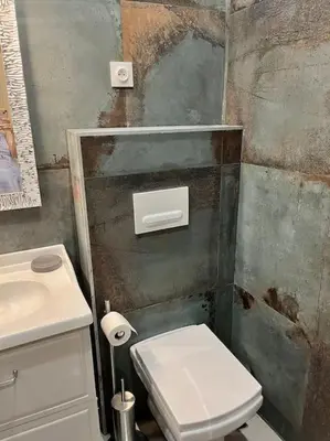 a bathroom with a white toilet and a sink at Vera Nizza in Nice