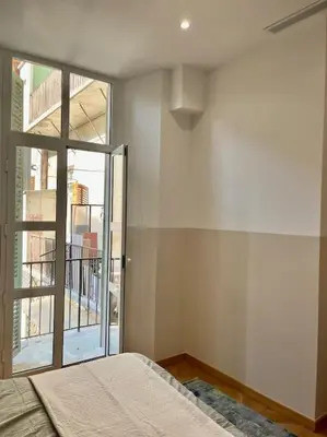 a bedroom with a bed and a large window at Vera Nizza in Nice