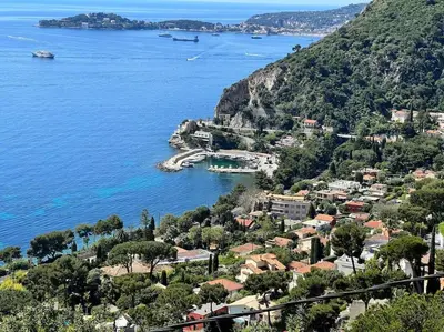 a kitchen with a white refrigerator and a sink at Entre les citronniers et la mer in Èze