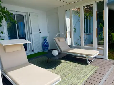 a porch with two chairs and a table at Villa Riviera vue panoramique MER et NATURE in Èze