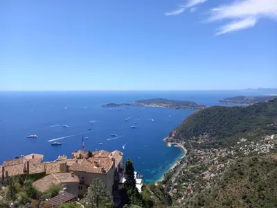 a view of a castle and a body of water at Villa Riviera vue panoramique MER et NATURE in Èze