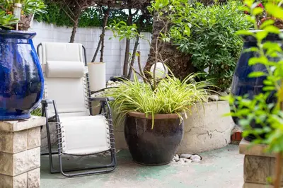 a patio with two chairs and a plant at Happyfew La Promenade 53 in Nice