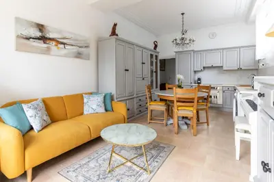 a living room with a yellow couch and a table at Happyfew La Promenade 53 in Nice