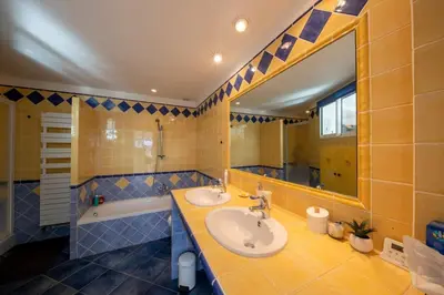 a bathroom with a sink and a tub and a mirror at 06C-Villa for 8 persons with pool near Nice in Tourrette-Levens