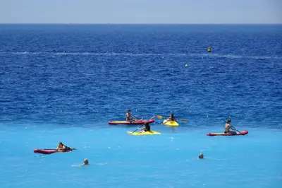 a group of people on kayaks in the water at 