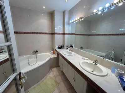 a bathroom with two sinks and a bath tub and a bath tub at Le Dante CLIM Balcon in Nice