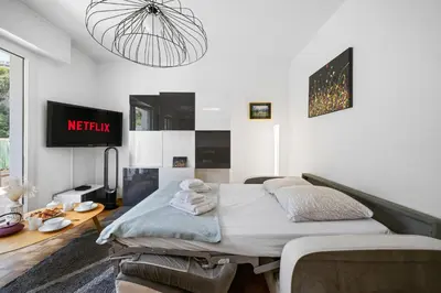 a bedroom with a bed and a pendant light at Ciel d'Orves - Terrasse Spacieuse- Parking privé in Nice