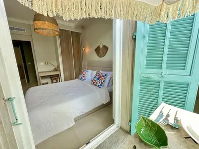 a bedroom with a bed with blue shutter doors at 3P neuf et climatisé Nice le Port à 9mn de la mer in Nice