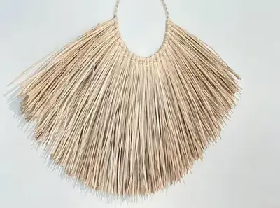 a tassel fringe necklace with a white background at 3P neuf et climatisé Nice le Port à 9mn de la mer in Nice