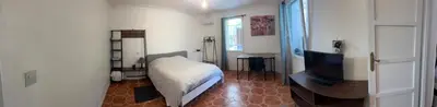 a bedroom with a bed and a flat screen tv at Villa CALIFORNIA in Nice