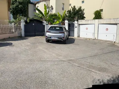a small silver car parked in a driveway at Villa CALIFORNIA in Nice