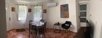 a kitchen with a table and chairs in a room at Villa CALIFORNIA in Nice