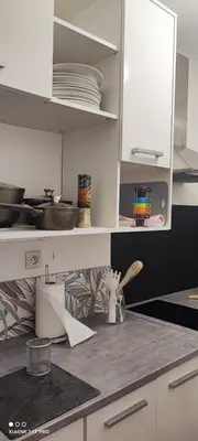a kitchen with white cabinets and a counter top at Villa CALIFORNIA in Nice
