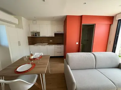 a living room with a couch and a table at Studio avec jardinet proche mer in Cagnes-sur-Mer