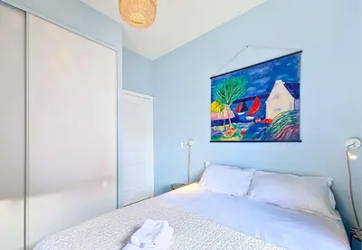 a bedroom with a bed and a painting on the wall at Nestor&Jeeves - PALAIS DU PORT - Balcony - Port Place du Pin in Nice