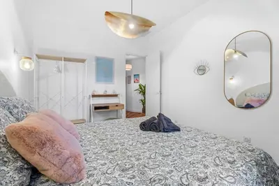 a bedroom with a bed and a mirror at Nice Renting - VERDI - Apartment Charm & Comfort & AirCon in Nice