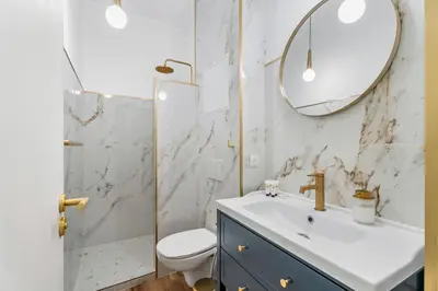 a bathroom with a sink and a toilet and a mirror at Nice Renting - VERDI - Apartment Charm & Comfort & AirCon in Nice