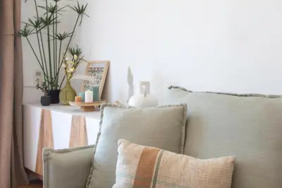 a couch with pillows and a shelf with plants at L54 1BDR Promenade Sea View AC & Balcony in Nice