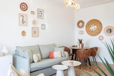 a living room with a blue couch and a table at L54 1BDR Promenade Sea View AC & Balcony in Nice