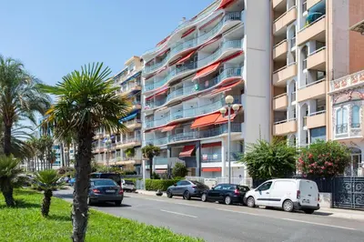 a building with cars parked on the side of a street at L54 1BDR Promenade Sea View AC & Balcony in Nice