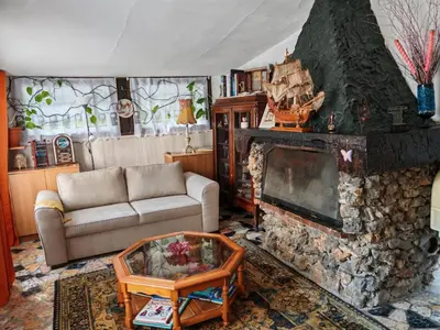 a living room with a couch and a fireplace at Maison dans l'arrière pays niçois entre mer et montagne in Tourrette-Levens