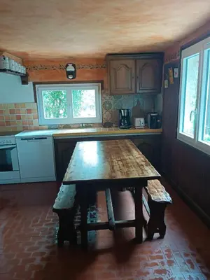 a kitchen with a wooden table in the middle at Maison dans l'arrière pays niçois entre mer et montagne in Tourrette-Levens