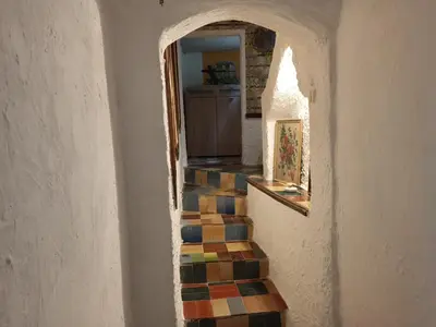 a hallway with a staircase with colorful tiles at Maison dans l'arrière pays niçois entre mer et montagne in Tourrette-Levens