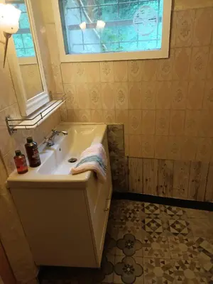 a bathroom with a sink and a window at Maison dans l'arrière pays niçois entre mer et montagne in Tourrette-Levens