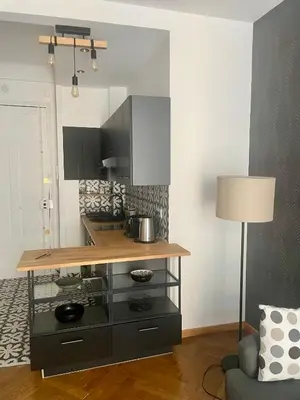 a kitchen with a counter and a table at Superbe Appartement au Cœur de Nice in Nice
