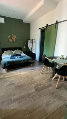 a bedroom with a bed and a table and chairs at Studio Californie beach in Nice