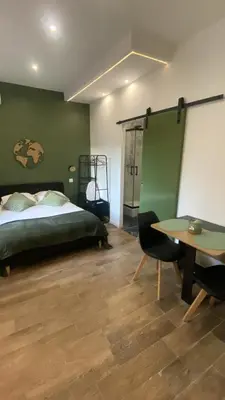 a bedroom with a bed and a desk and a table at Studio Californie beach in Nice