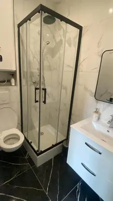 a shower in a bathroom with a toilet and a sink at Studio Californie beach in Nice