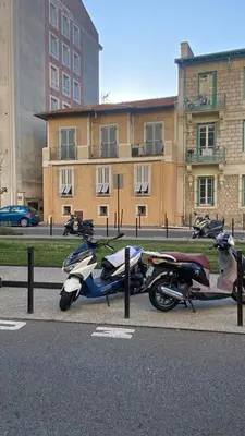 a group of motorcycles parked on the side of a street at Studio Californie beach in Nice
