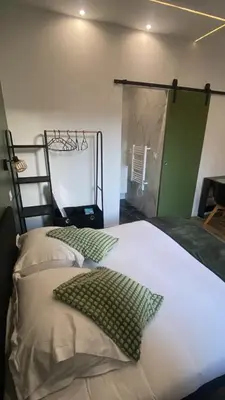 a bedroom with two beds and a green door at Studio Californie beach in Nice