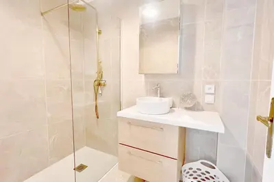 a white bathroom with a sink and a shower at Le Villermont - Liberation Centre Ville in Nice
