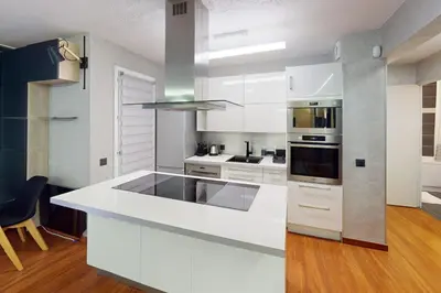 a kitchen with white cabinets and a white counter top at Cozy Apt with Balcony - 5 min to the Beach in Nice