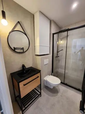 a bathroom with a toilet and a sink and a mirror at Nice Fac St Jean D'Angely in Nice