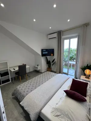 a bedroom with a large bed and a window at LEî in Beaulieu-sur-Mer