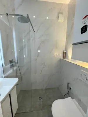 a bathroom with a shower and a toilet and a sink at LEî in Beaulieu-sur-Mer