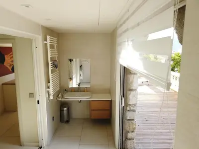 a bathroom with a sink and a mirror at Villa spacieuse, totalement adaptée aux normes PMR in Nice