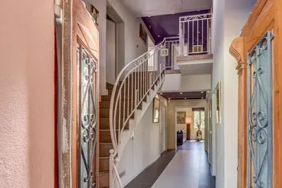 a hallway with a staircase with wooden railings at Villa spacieuse, totalement adaptée aux normes PMR in Nice
