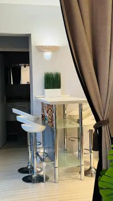 a dining room with a table and stools at Eze flat with terrace sea view and mountain view in Èze