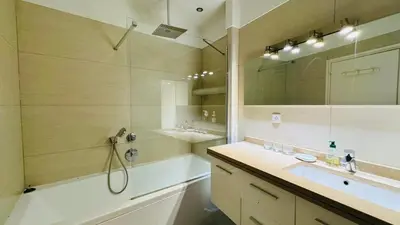 a bathroom with a tub and a sink and a shower at Eze flat with terrace sea view and mountain view in Èze