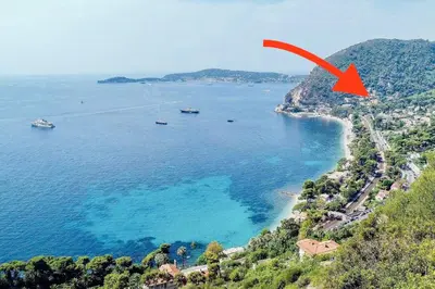an aerial view of a beach with a red arrow at Eze flat with terrace sea view and mountain view in Èze